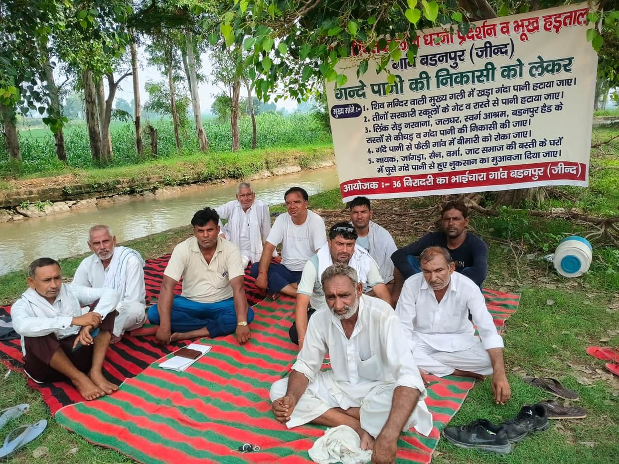 Angry villagers staged a sit-in protest after sewage was not drained for eight months.