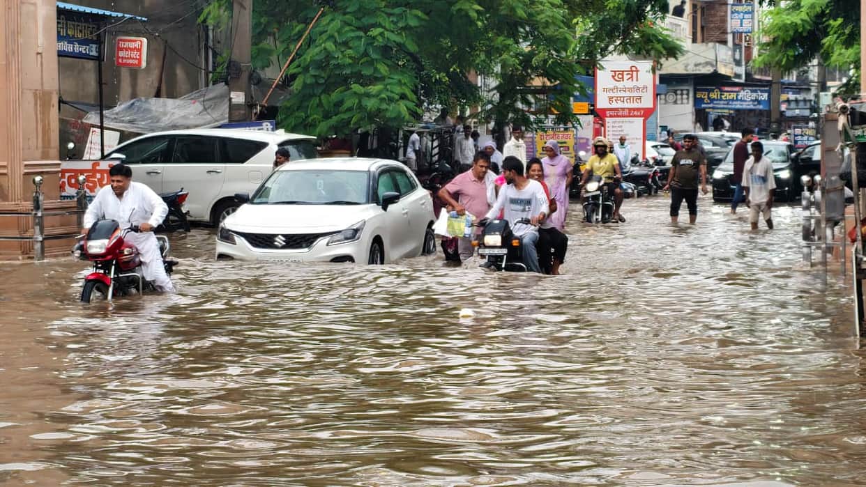 Claims washed away by an hour of rain; city's pace comes to a halt.