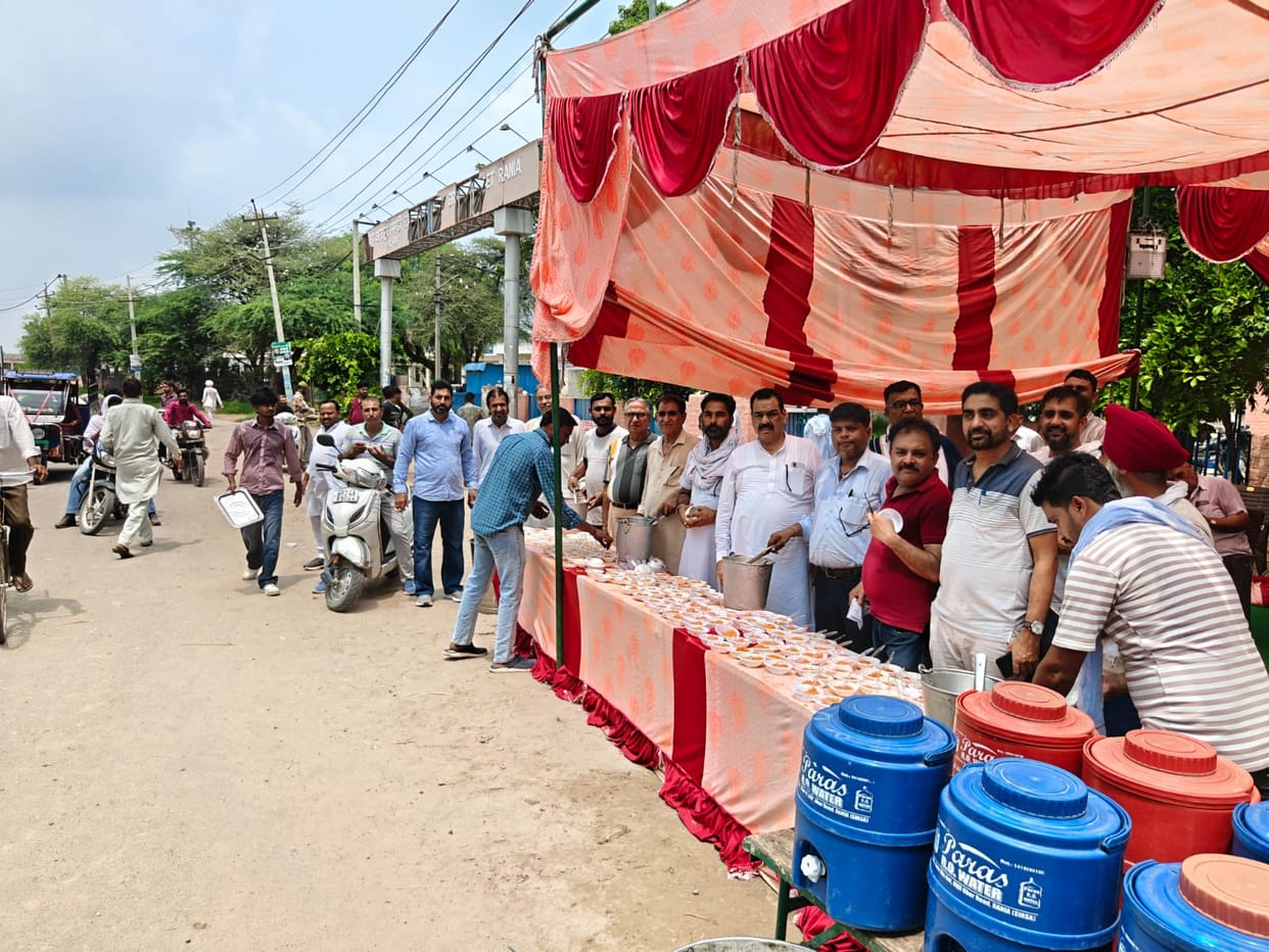 Commission agents' association organizes community feast; halwa distributed.
