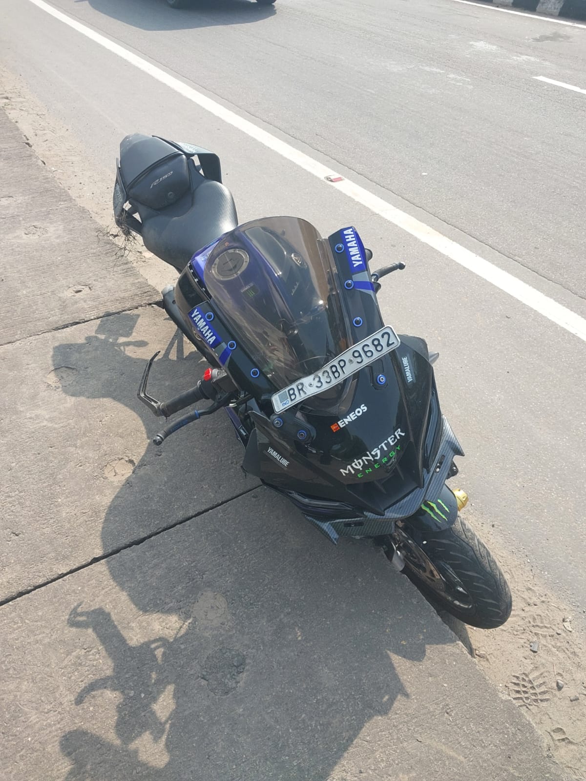 Bike crashes into divider after being hit by car; truck runs over student, killing him.