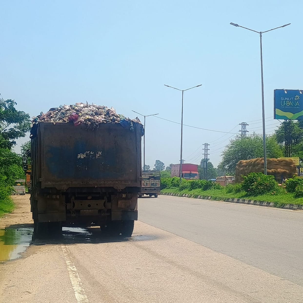 Garbage spilling onto the road from overloaded tippers; residents troubled.