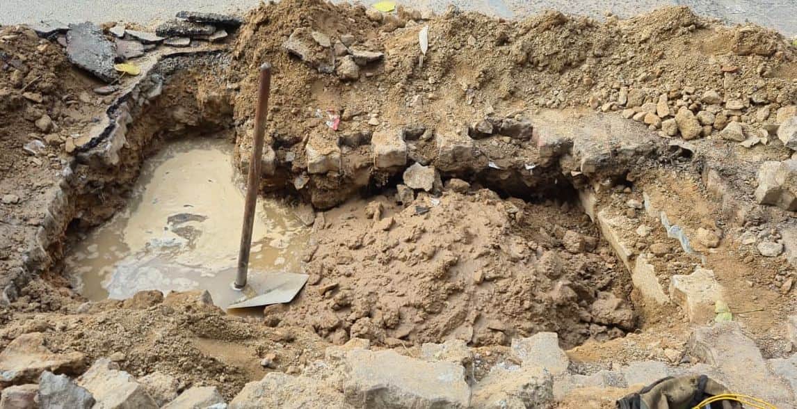 शहर में  लीकेज ठीक करने के लिए खोदा गड्ढा।