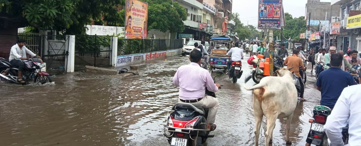 Drains overflowed following three hours of heavy rain; water entered shops.