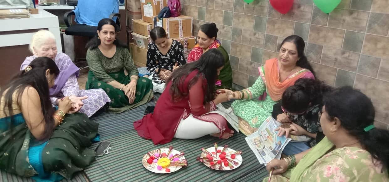 Applying henna on hands for Hariyali Teej.