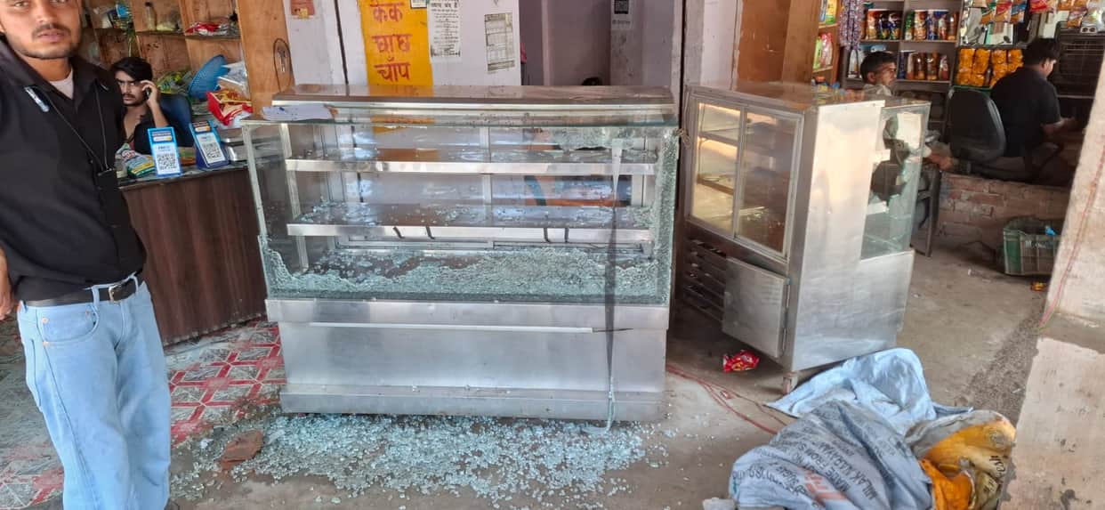 Assault and vandalism at a shop over a monetary transaction.
