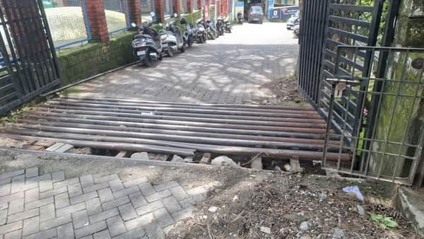Broken gate mesh at Dharamshala hospital increases risk of accidents.