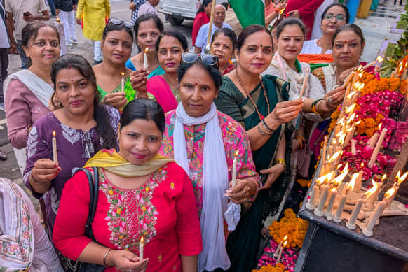 Shaheed Path illuminated by lamps; martyrs honored with floral tributes.