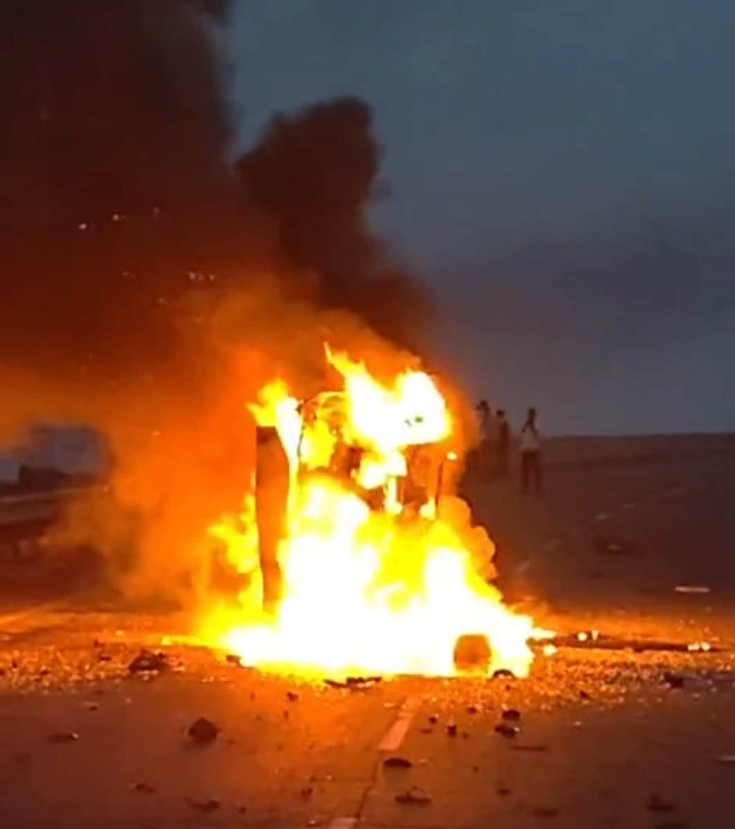 Car catches fire after hitting divider due to tyre burst; mechanic dies.