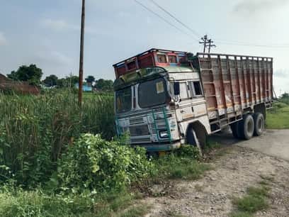 Truck goes out of control and plunges into a ditch due to steering failure; driver dies after being crushed underneath.