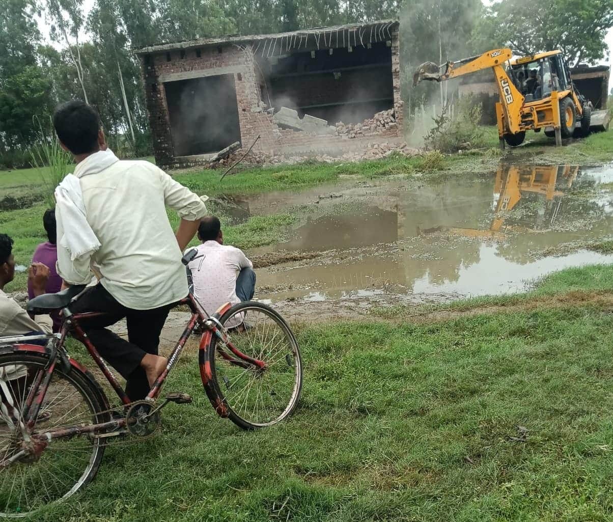 Huts in Kadamnagala are being swallowed by the Ganges; villagers are having their concrete houses demolished using JCBs.