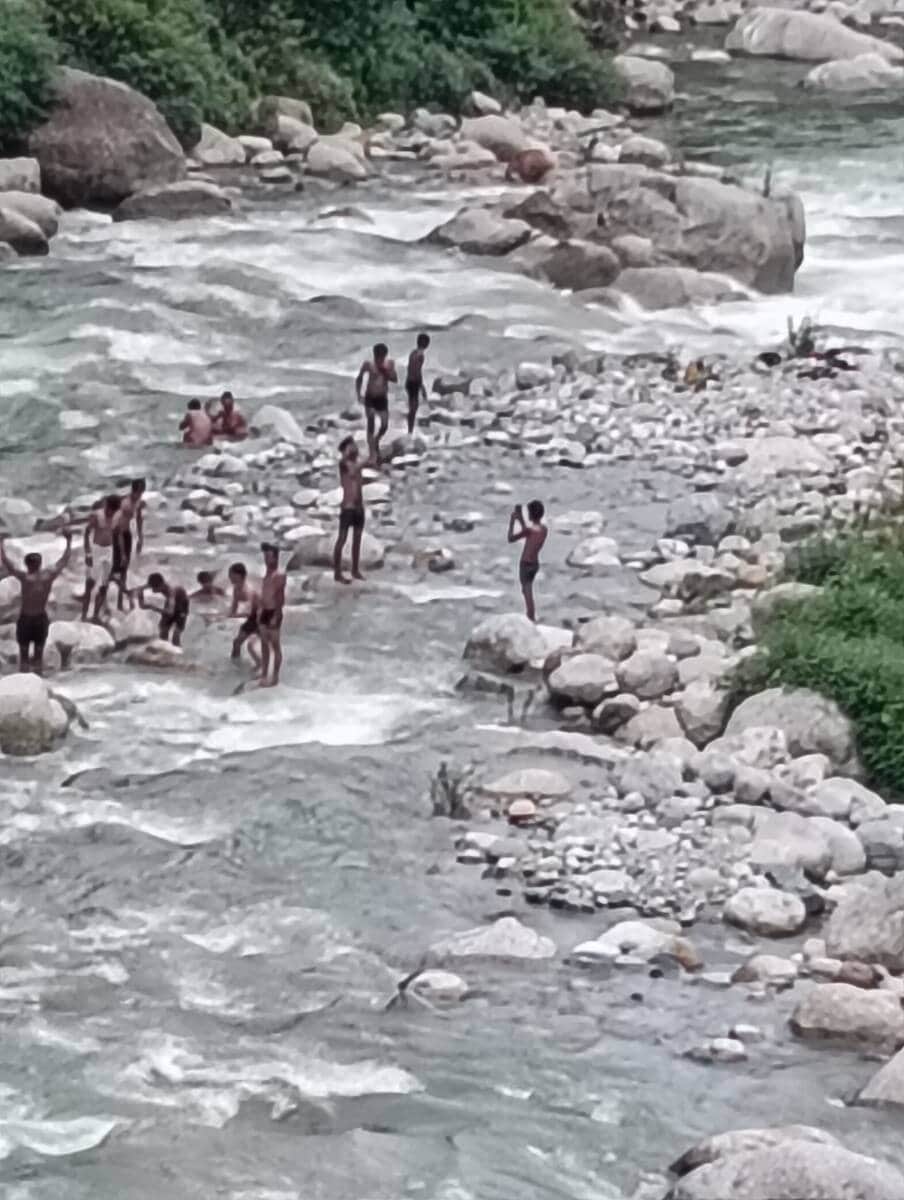 Devotees are risking their lives by venturing into the swollen ravine.