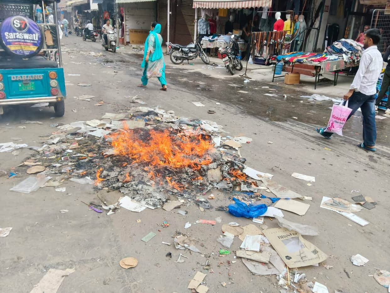 200 tonnes of waste being cleared; shopkeepers burning it on the streets.