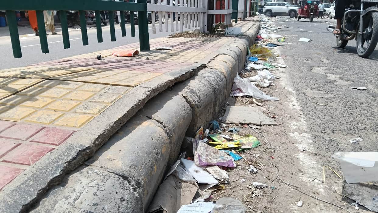 Rain exposes the reality of the dividers; interlocking tiles scattered across the road