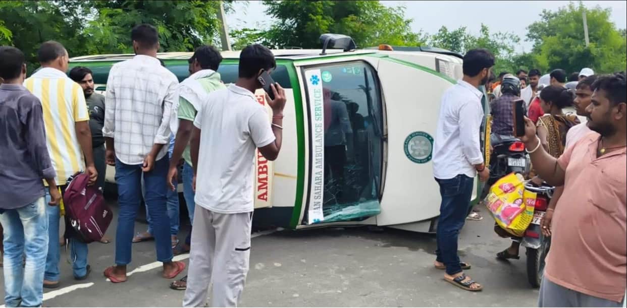 Ambulance overturns while overtaking a Scorpio; two injured, traffic jam ensues.