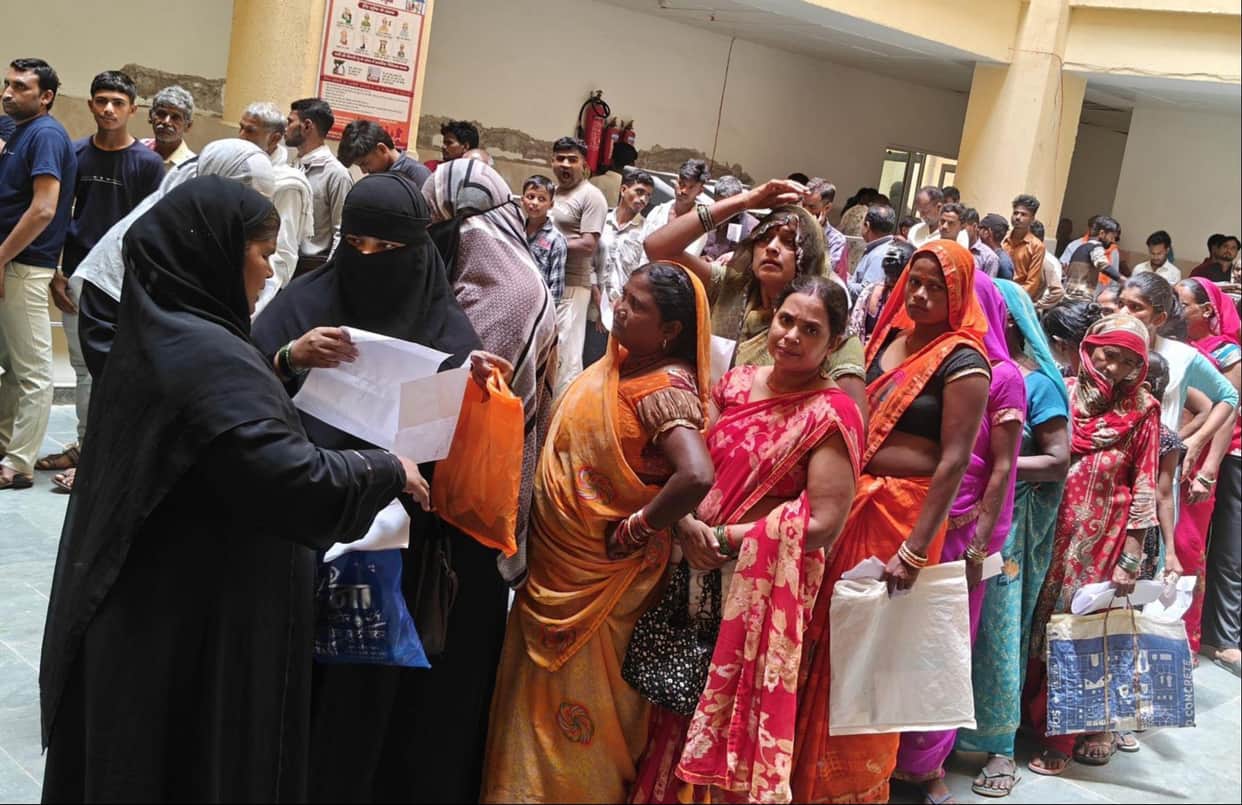 Patients had to sit on the floor while waiting for their turn.