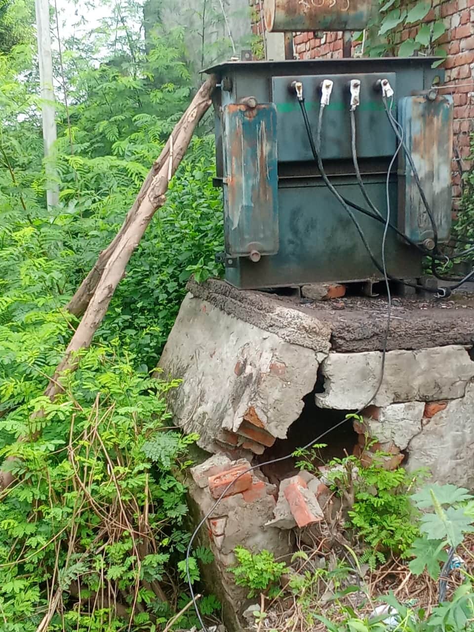 Transformer propped up by poles in Godha.