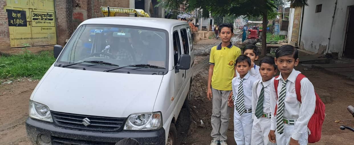 School vehicle gets stuck in a swamp; villagers help get it out after offloading the children.