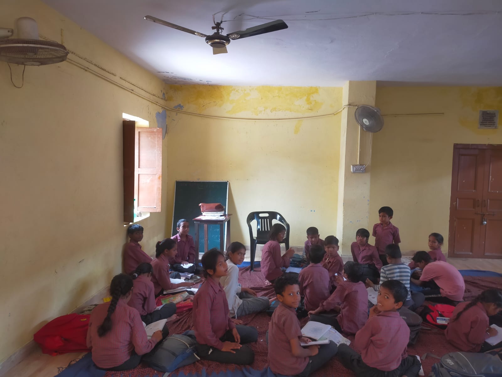17 months later, the situation remains unchanged; 63 children study on mats.
