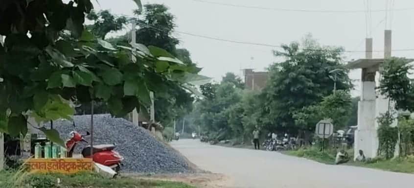 Roads and verges encroached upon by stockpiles of gravel and sand.