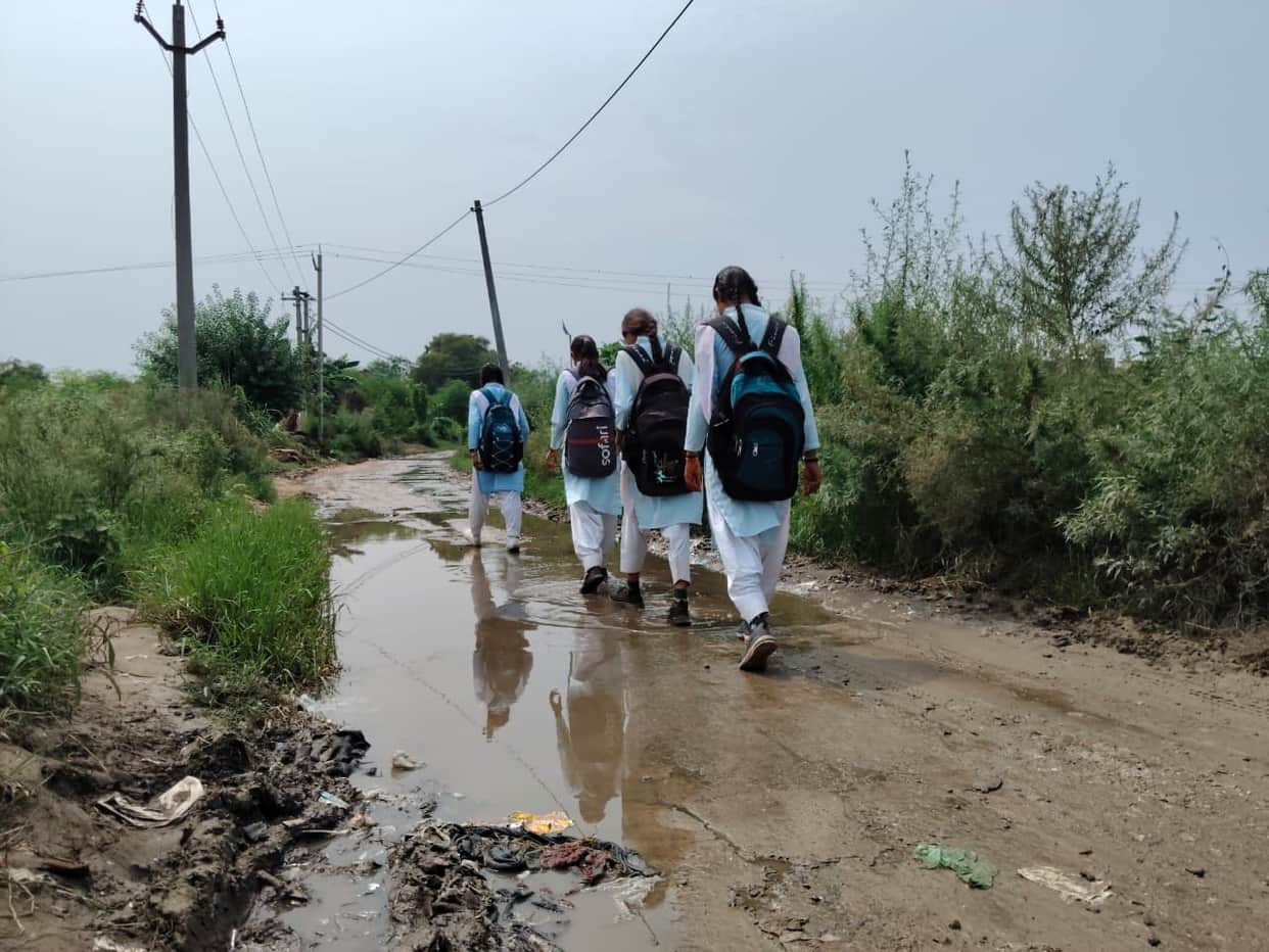 Three years spent waiting for a paved road; conditions turn miserable during the rains.