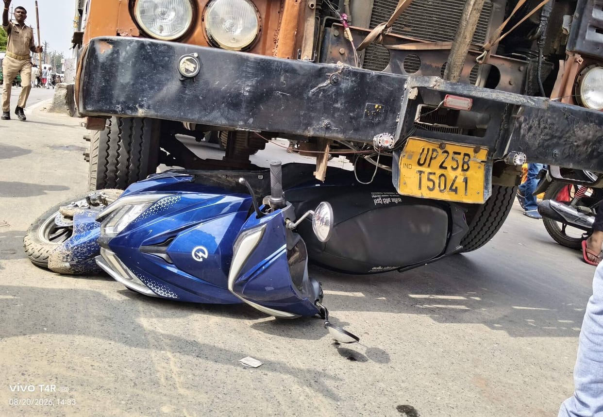 A young woman riding a scooter narrowly escaped being hit by a truck; the driver is in custody.