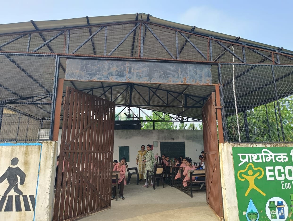 A tale of misery: Students from five classes study under a tin shed.