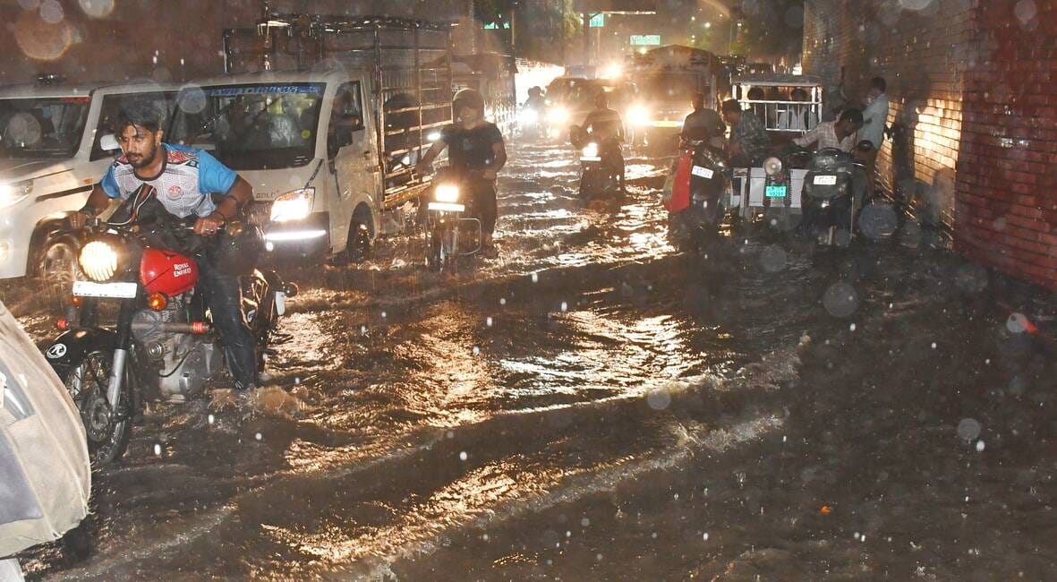 Relief from the heat due to heavy rain; waterlogging on roads caused difficulties.