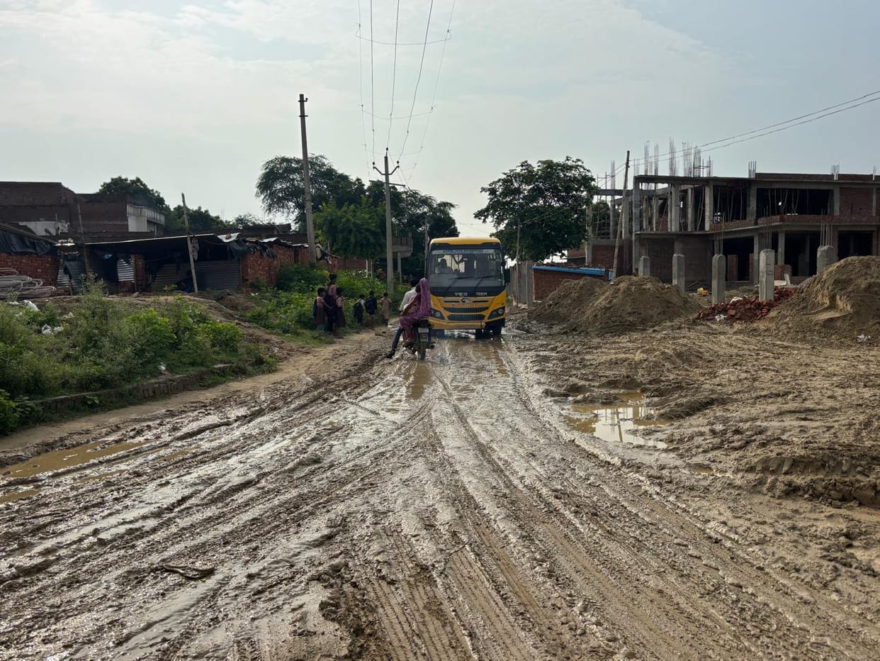 Potholes and mud on the road make it difficult for villagers to move around