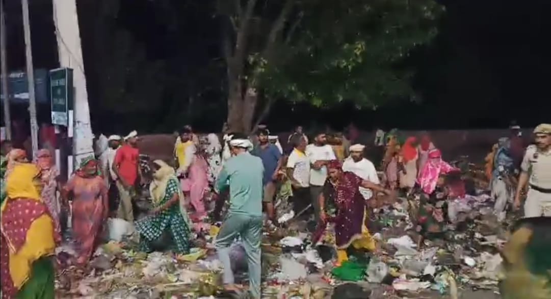 Garbage cleared under police escort; 150 sanitation workers detained for protesting.