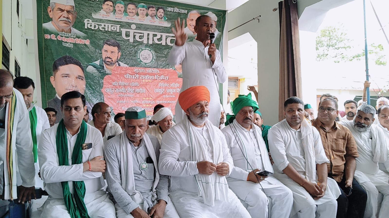 मंगनपुर गांव में किसान पंचायत में मंच पर मौजूद किसान नेता राकेश टिकैत  और अन्य किसान : संगठन