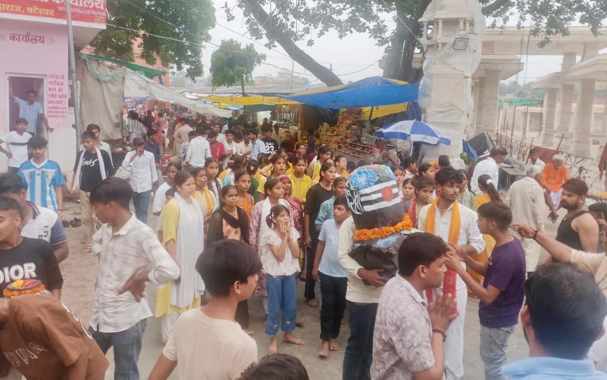 Enthusiasm of women's power on display; female students arrive carrying Kanwars on foot.
