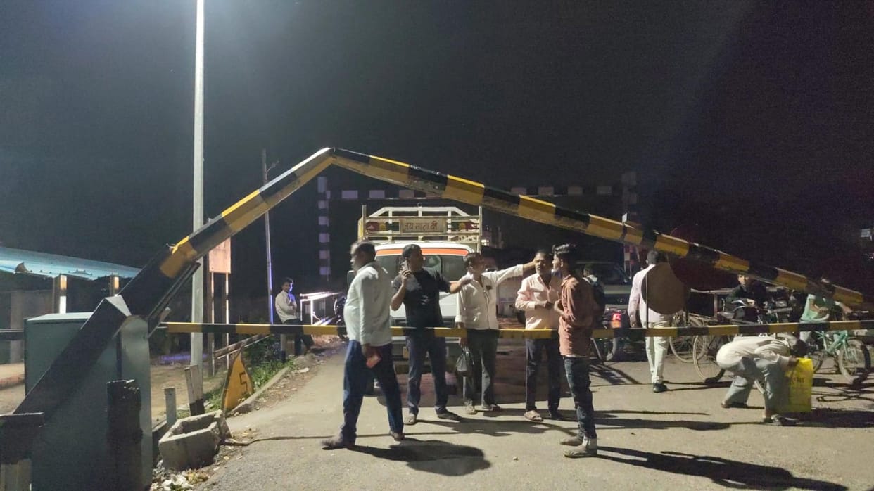 Pickup truck hits railway crossing boom; it breaks and strikes HT line.