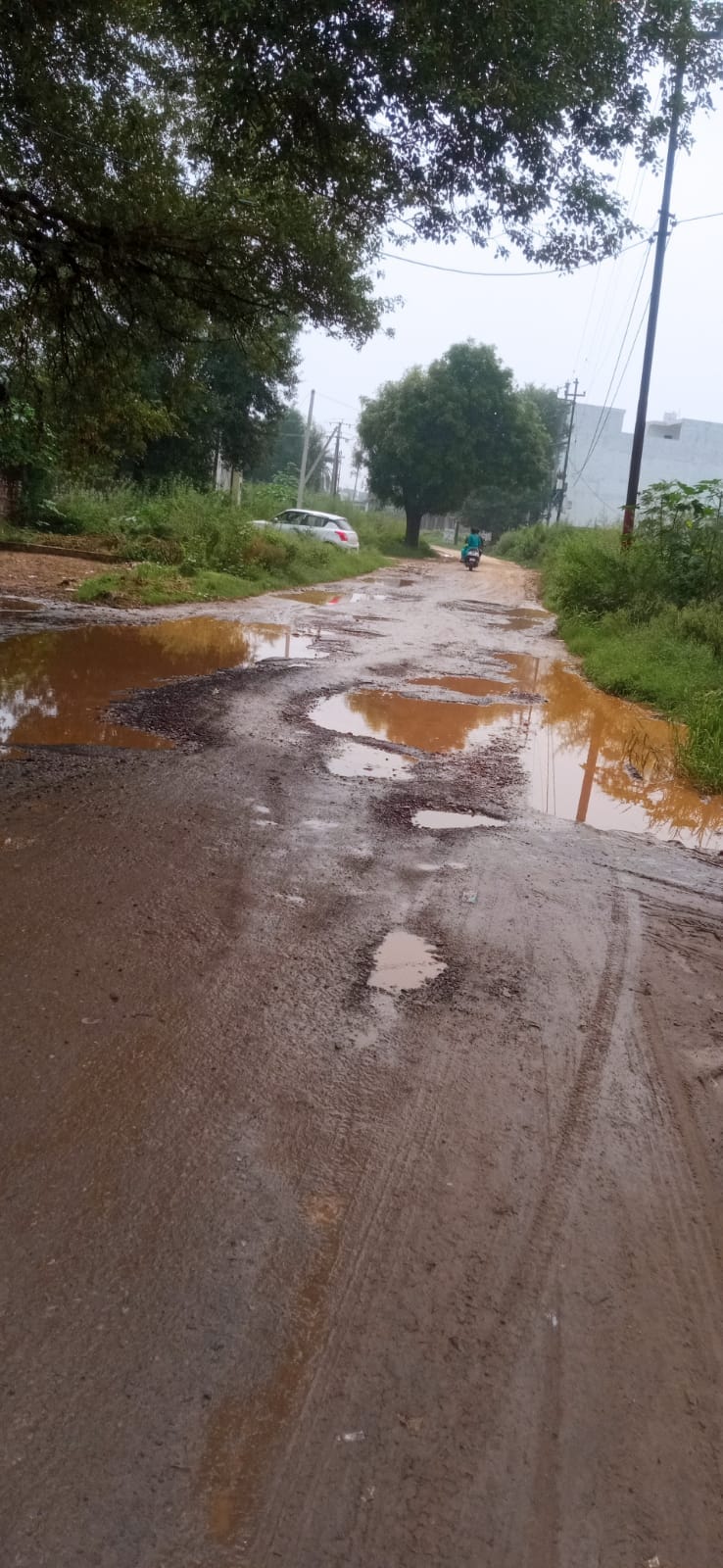Commuters troubled by potholes and waterlogging on roads.