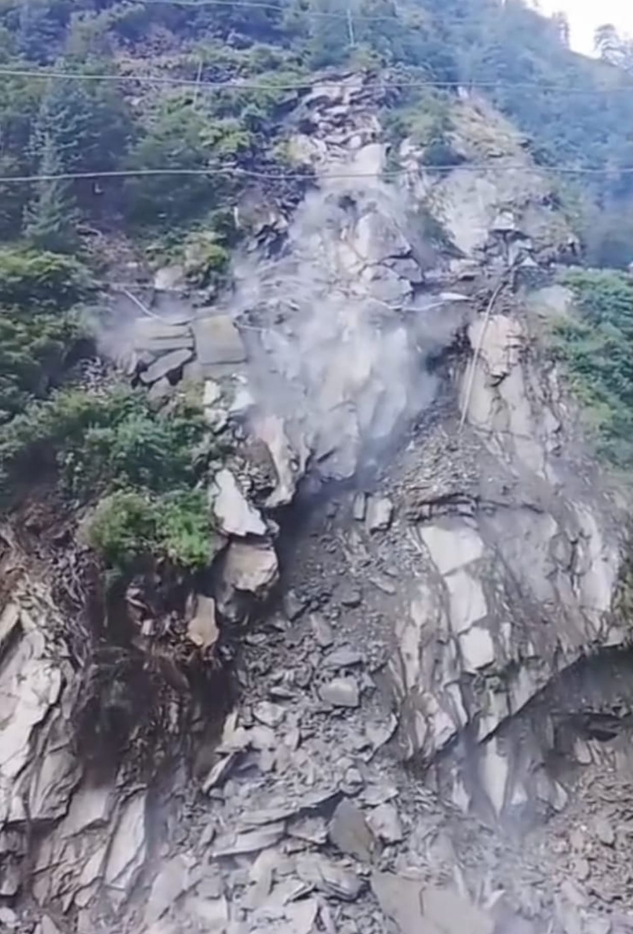Hillside collapses; 40-meter stretch of road caves in.