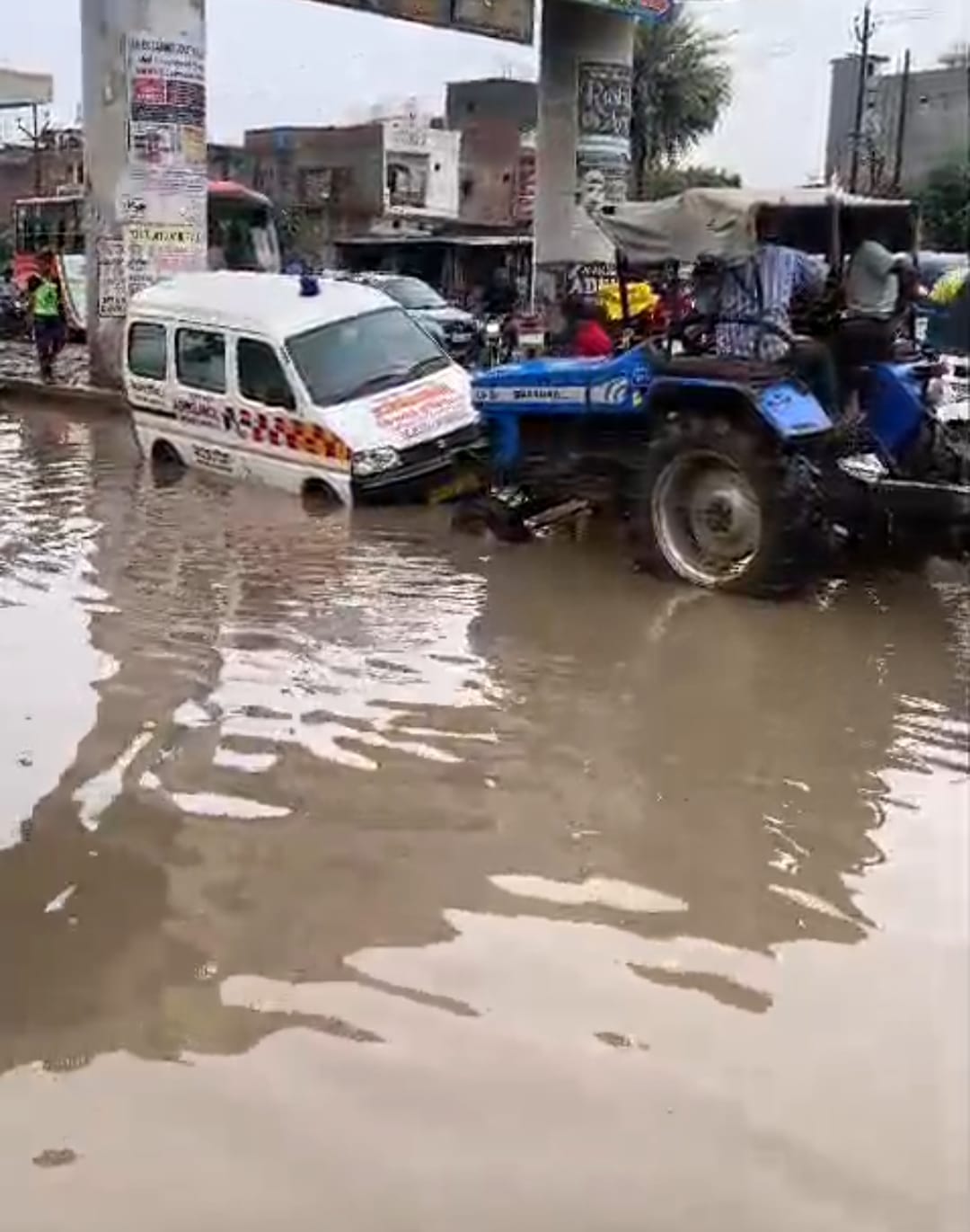 Ambulance breaks down on the road; bike rider injured after falling into a pothole.