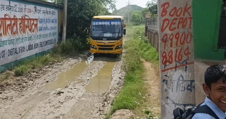 Water-filled potholes pose a danger to children going to school.