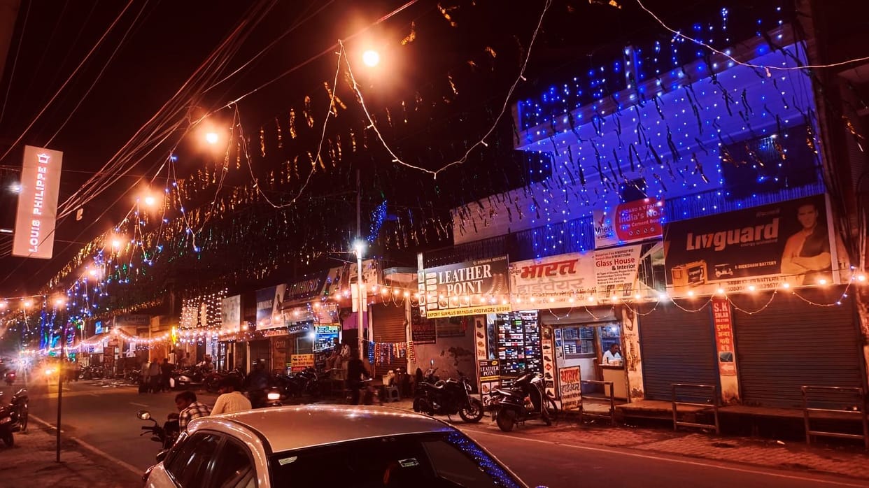 The city illuminated by colorful strings of lights.