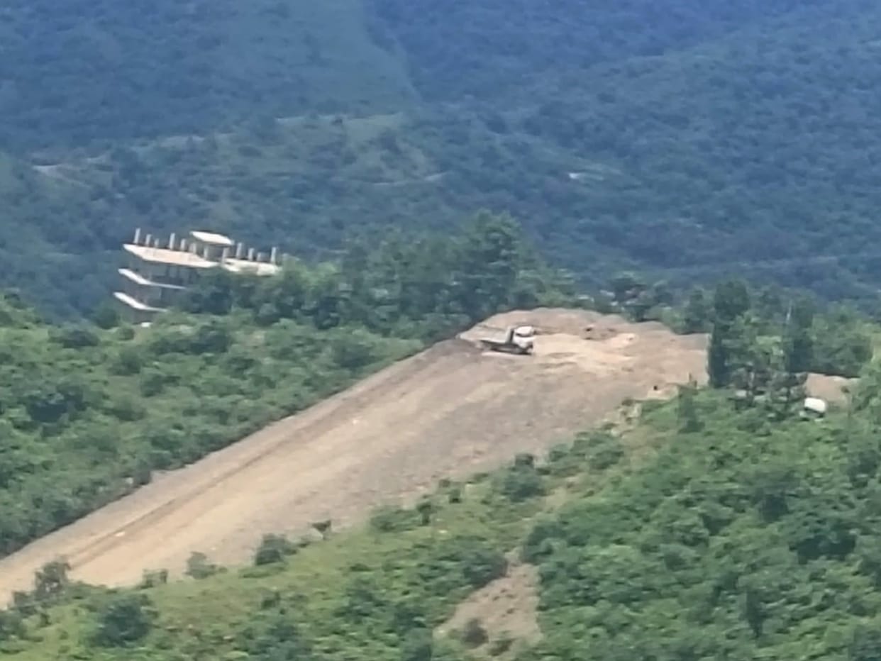 Debris from the dumping site has started reaching land owned by villagers.