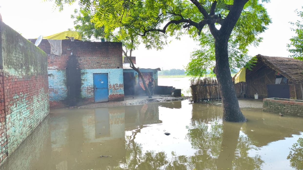 Chachupur village surrounded by floodwaters; water entering homes.