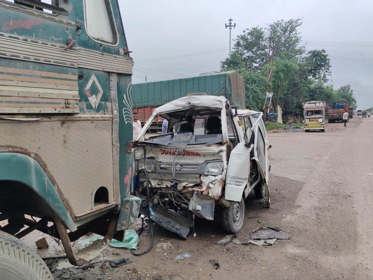 Ambulance crashes into stationary truck; driver dies.