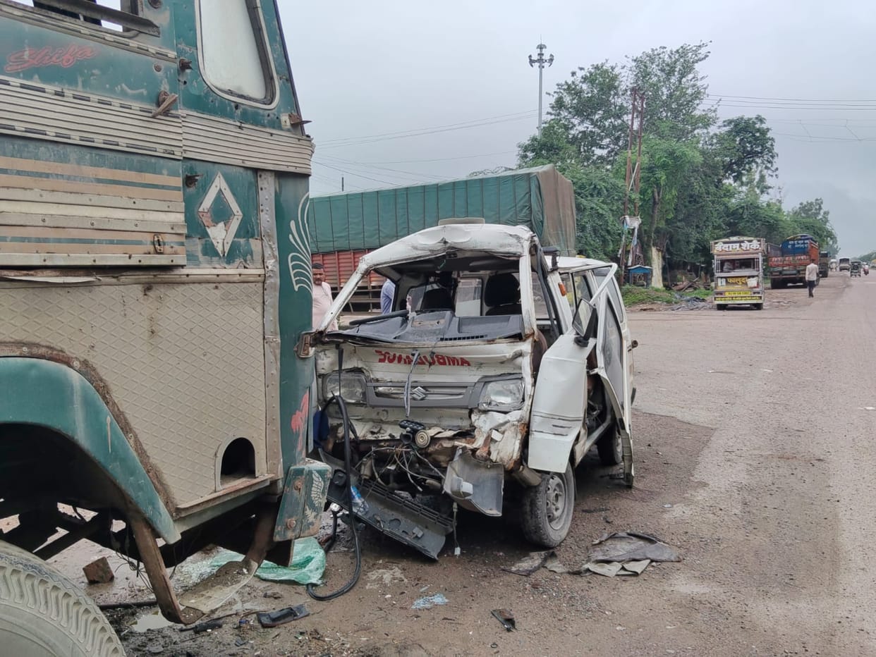 Ambulance crashes into stationary truck; driver dies.