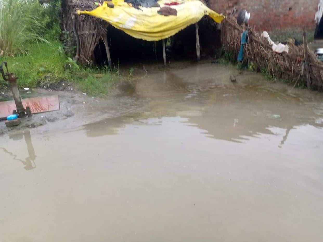 Villages surrounded by floodwaters from the Ganga and Ramganga rivers; water flowing over the highway.