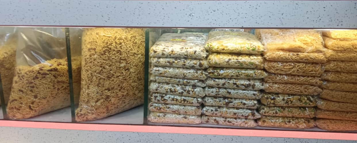 Traders selling savory snacks without expiry dates.