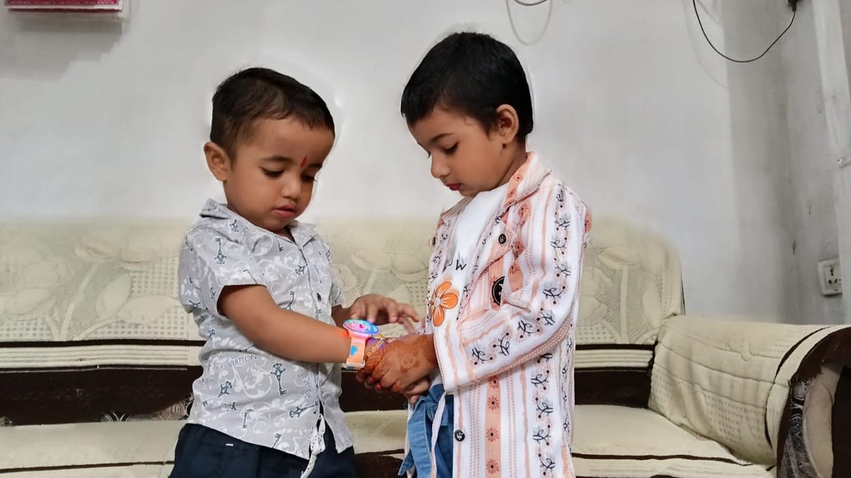After applying a *tilak* to their foreheads, sisters tied the *Raksha Sutra* on their brothers' wrists.