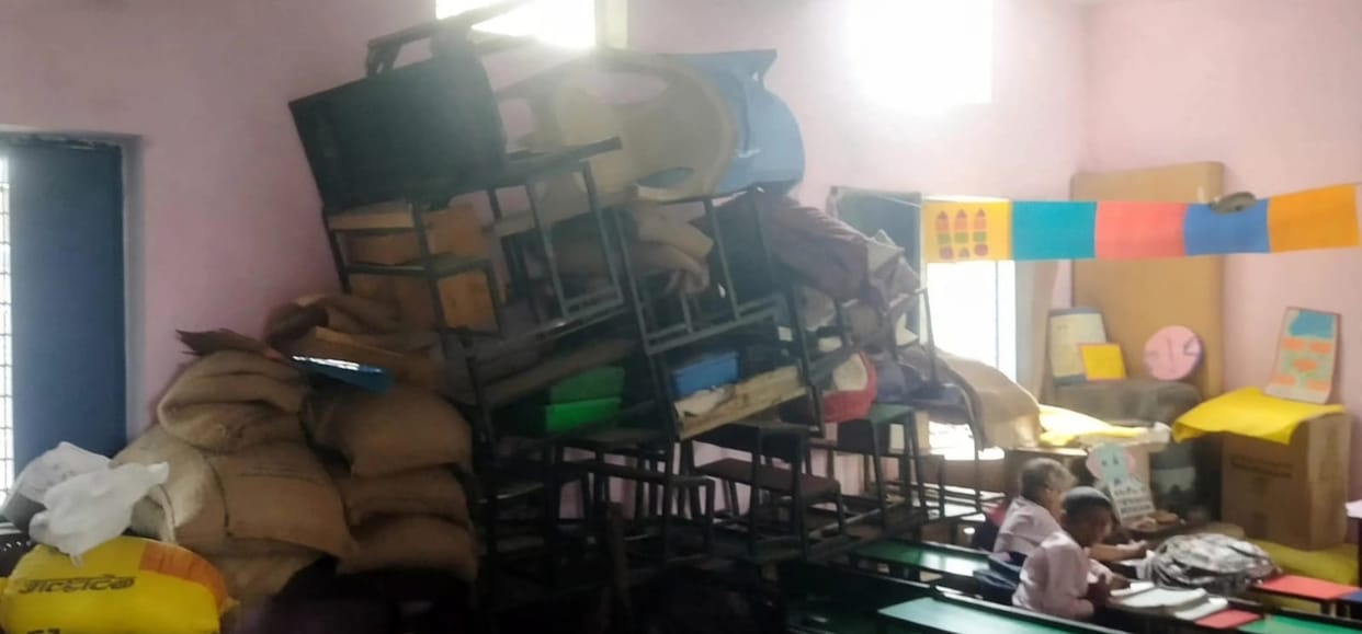 Five classes in a single room; mid-day meal prepared alongside lessons.