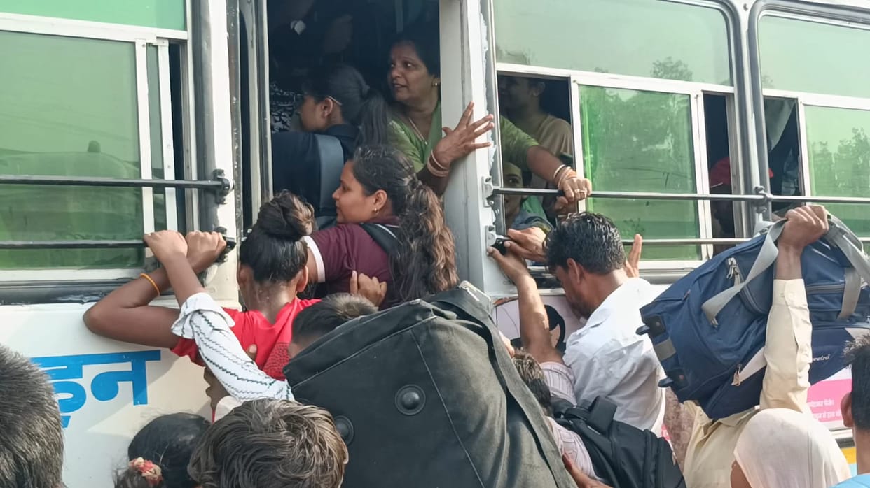 There wasn't even standing room, yet passengers jostled and shoved their way onto the buses.
