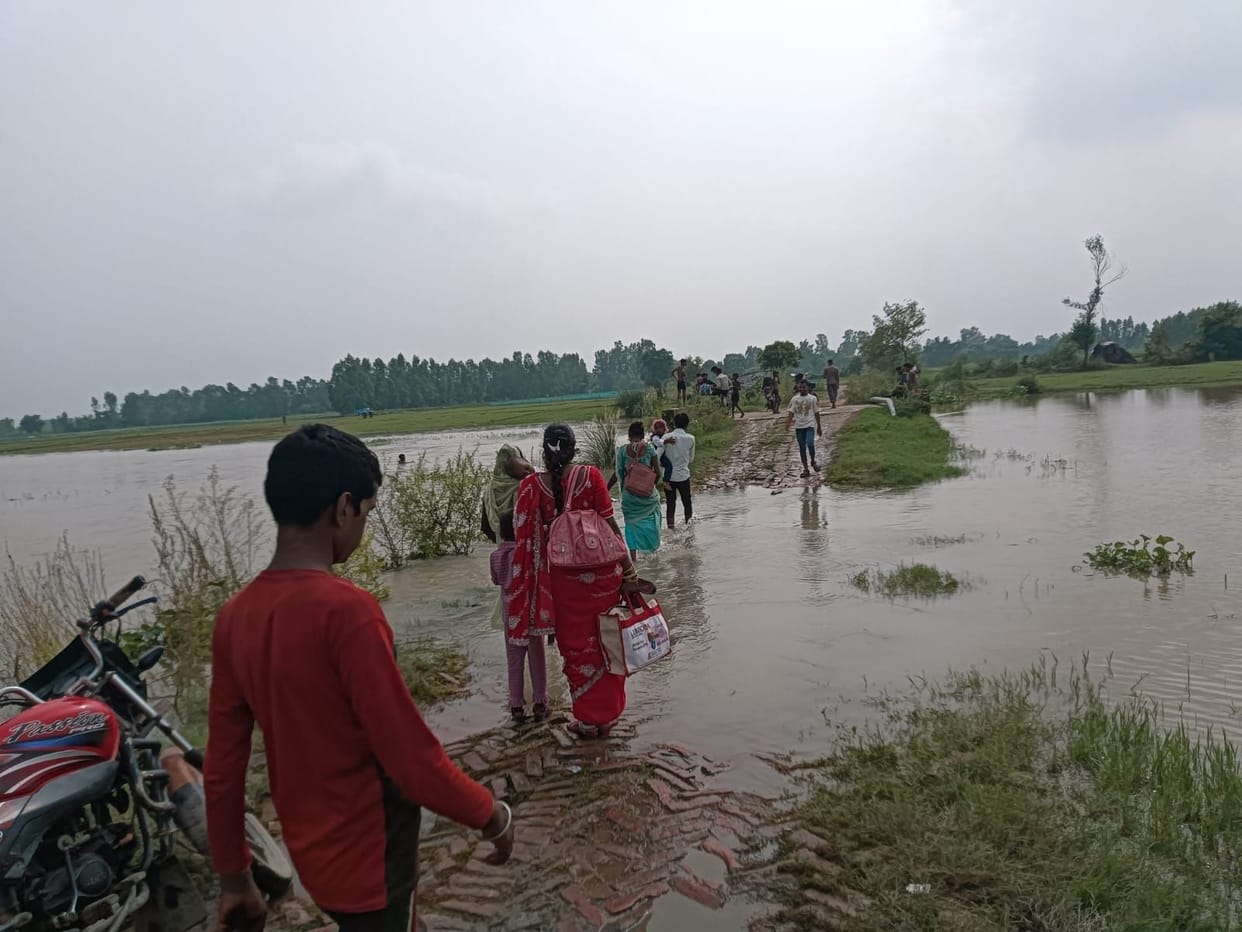 Rising water levels have submerged roads, making travel hazardous.