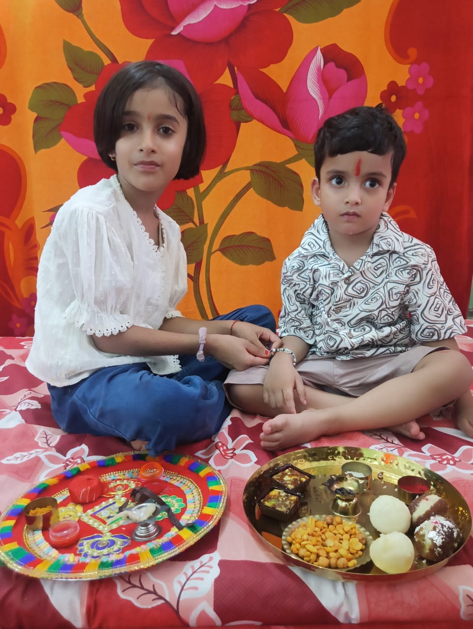 Sisters tied the Rakhi on their brother's wrist, performed the aarti, and applied the tilak.