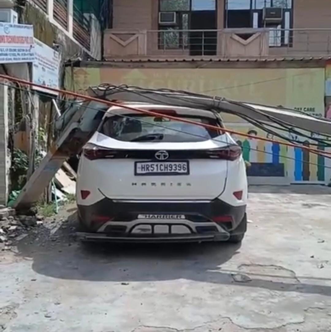 Electric pole falls on car