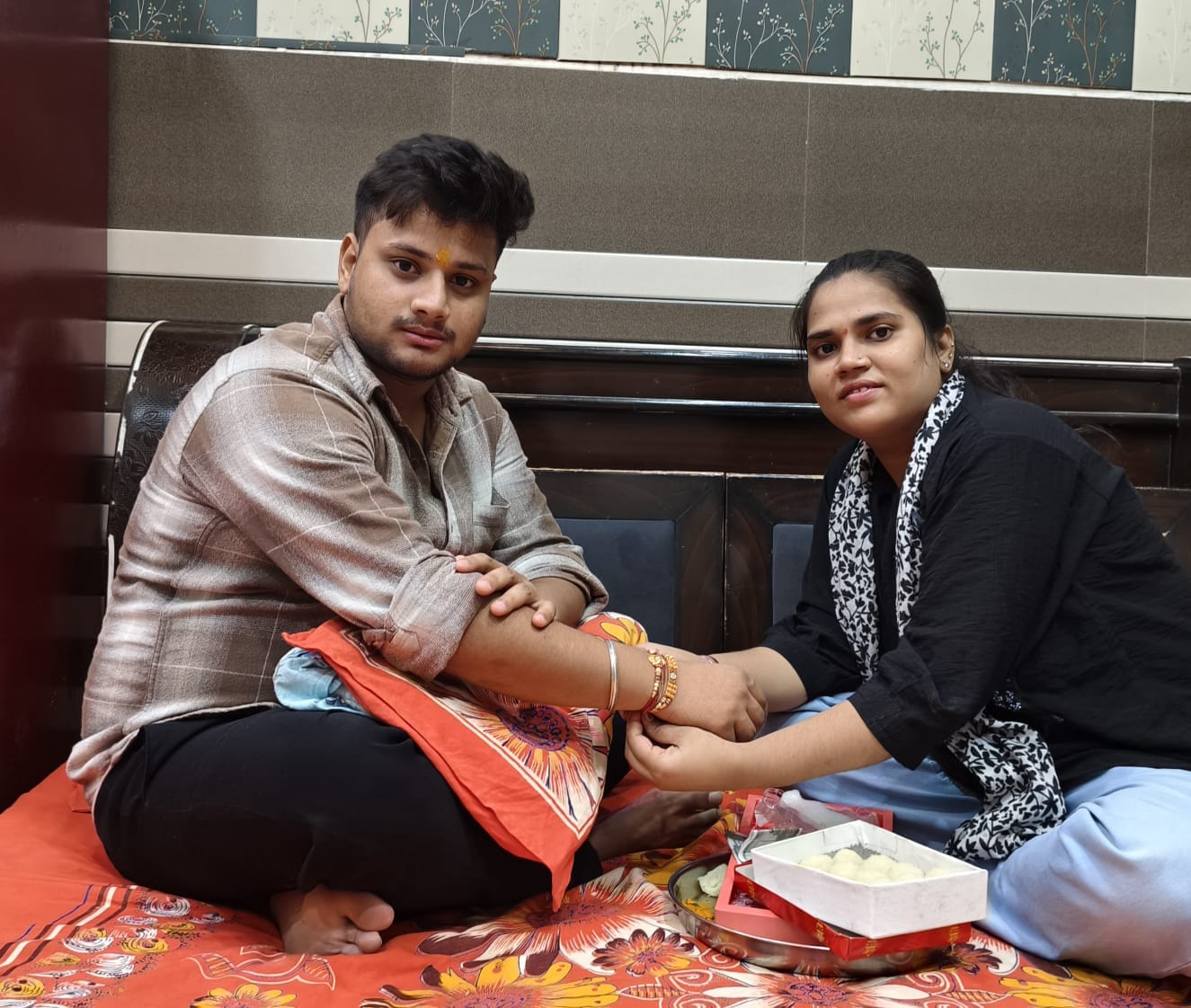 शहर के दयानंदनगर में भाई को राखी बांधती बहन। संवाद